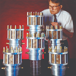 Various ATI Products on Display with Worker Standing Behind Them